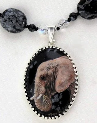 A Snowflake Obsidian Pendant With Elephant